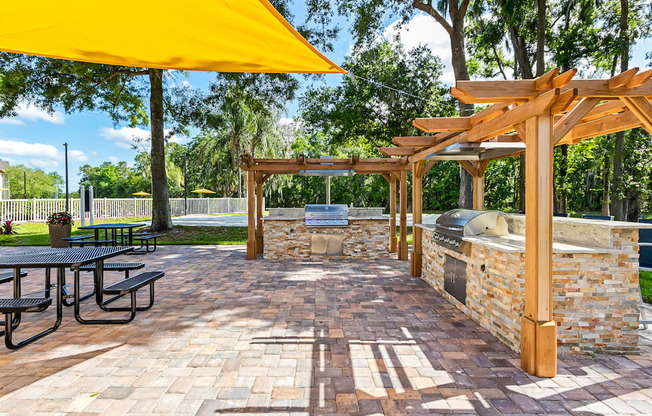 Outdoor Grilling Area with Pergolas and Picnic Tables