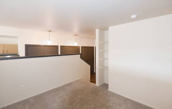 a living room with a carpeted floor and a white wall