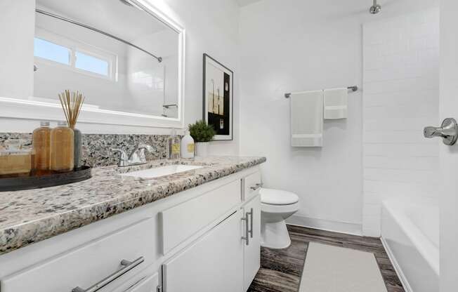 a white bathroom with a sink and a toilet