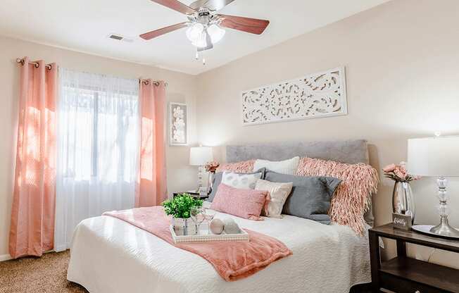 a bedroom with a large bed and a ceiling fan