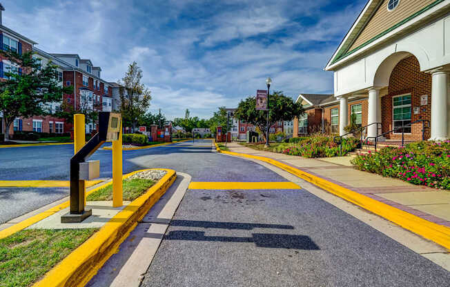 an empty street in a town with buildings and a street sign at MetroPlace at Town Center, Camp Springs