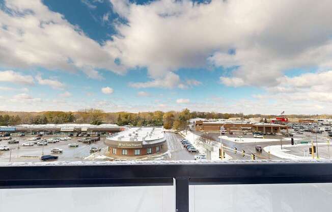 A parking lot with a circular building in the middle.