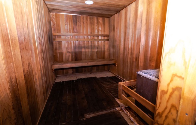 an empty sauna with wooden walls and floors
