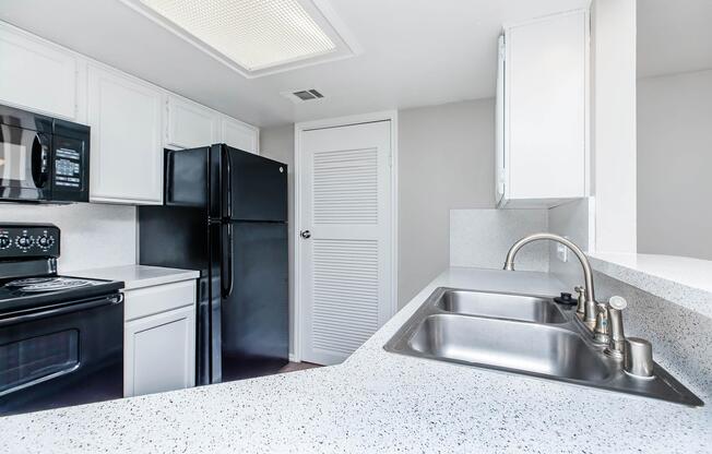 a kitchen with a sink and a microwave