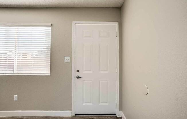 A white door is in a room with a window at Sterling Point Apartment Homes, Phoenix, Arizona