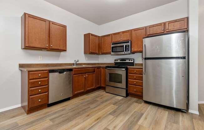 A kitchen with wooden cabinets and stainless steel appliances.