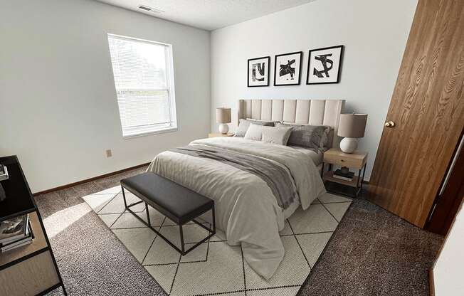 A bedroom with a large bed and a bench in front of it.
