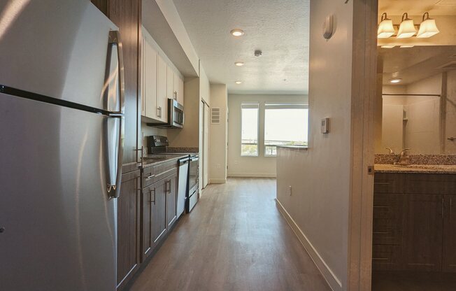 A kitchen with white cabinets and stainless steel appliances