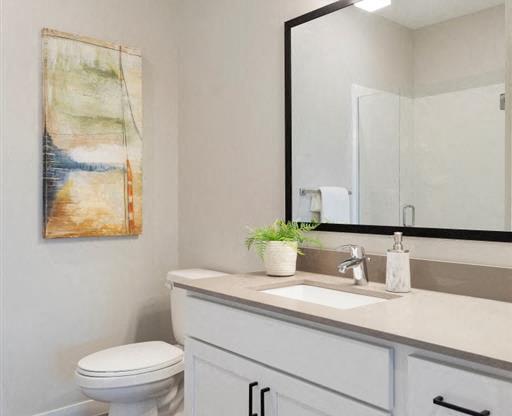 A bathroom with a toilet, sink, and a mirror.