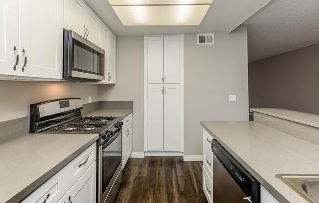 a kitchen with a stove sink and refrigerator