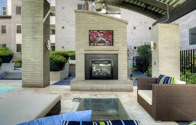 A patio with a fireplace and a couch.