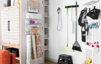 a small room with a closet and a chair and an orange couch