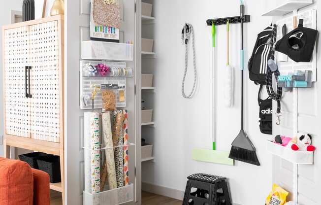 a small room with a closet and a chair and an orange couch