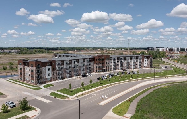 an aerial view of an empty parking lot with apartment buildings