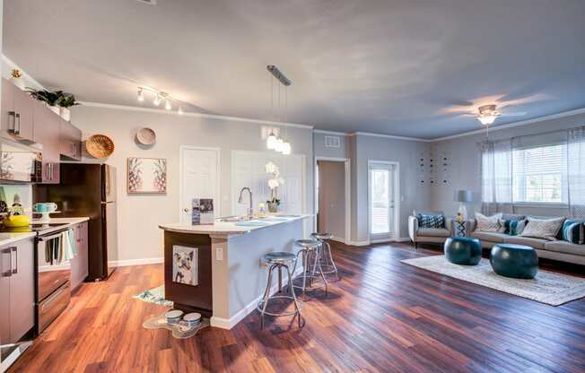 a living room with a kitchen and an open floor plan