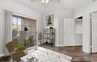 a living room with white walls and a sliding glass door