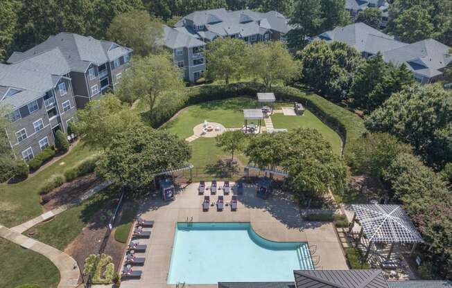 an aerial view of an apartment complex with a pool