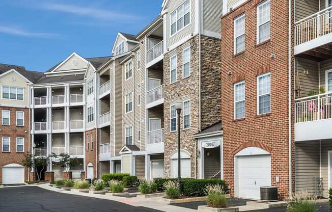 an apartment building with brick exterior and white balconies