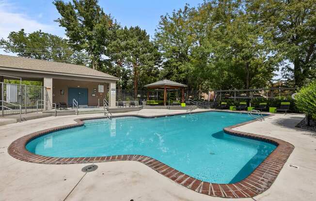 the preserve at ballantyne commons pool and spa with trees and a building