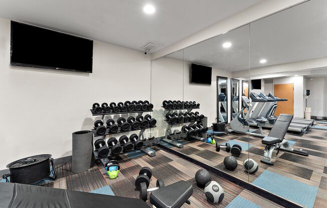 A well-equipped gym with a variety of exercise equipment.