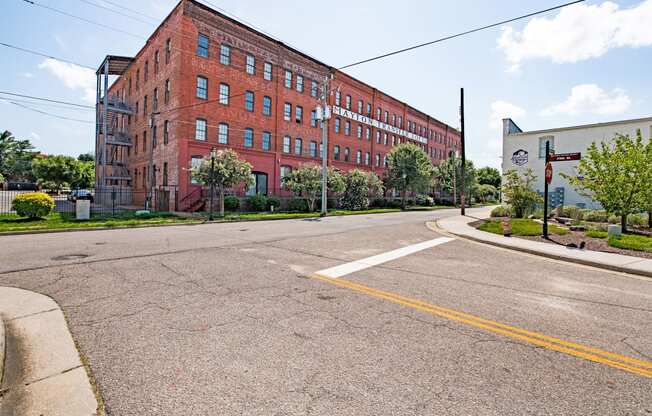 an empty street in front of a red brick building