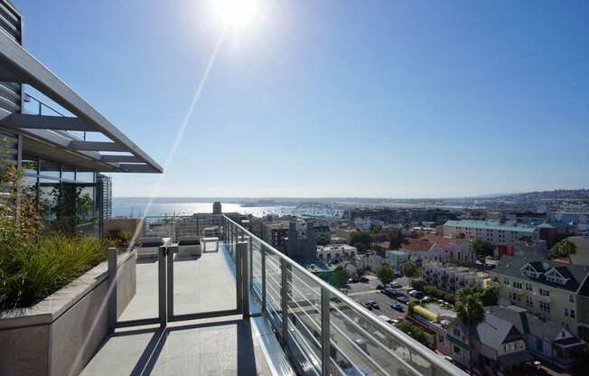 a balcony with a view of the city and the ocean