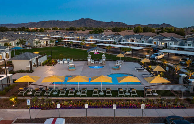 aerial view of pool, houses and mountains