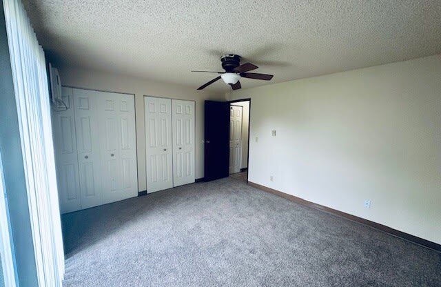 a living room with a ceiling fan in it