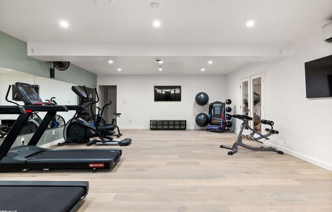 the gym is equipped with treadmills and other exercise equipment