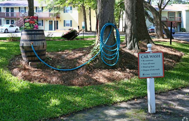 a car wash hose is plugged into a tree