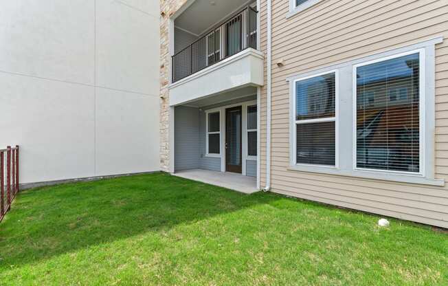 A balcony with a railing is on the second floor of a house.