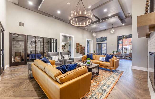 A living room with a tan couch and a rug.