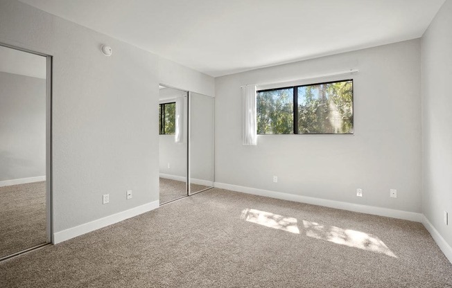 Brody Terrace Bedroom with Mirrored Closet Doors and Carpet