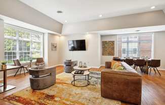 a living room with a couch and chairs and a tv