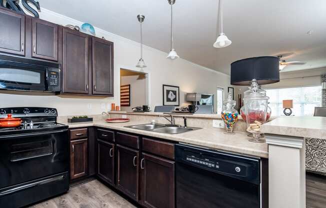 Breakfast bar with view of living room in Riverstone apartments for rent in Macon, GA