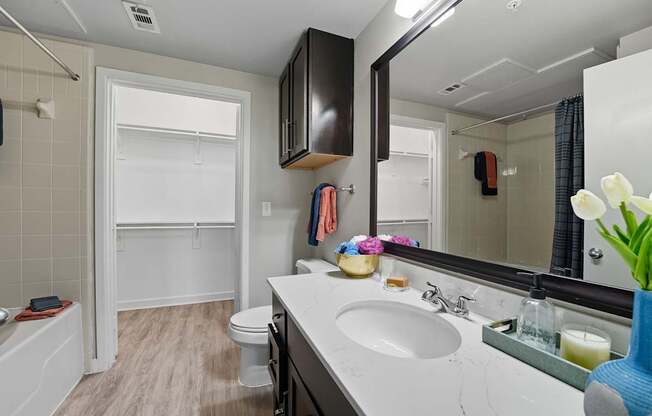 A bathroom with a white sink and a white toilet.