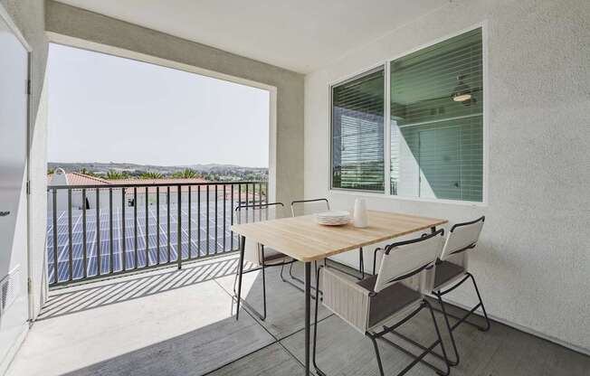 A balcony with a table and chairs overlooking a pool at Montecito at Carlsbad, Carlsbad, CA 92010