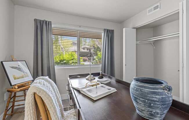a dining room with a table and chairs and a window