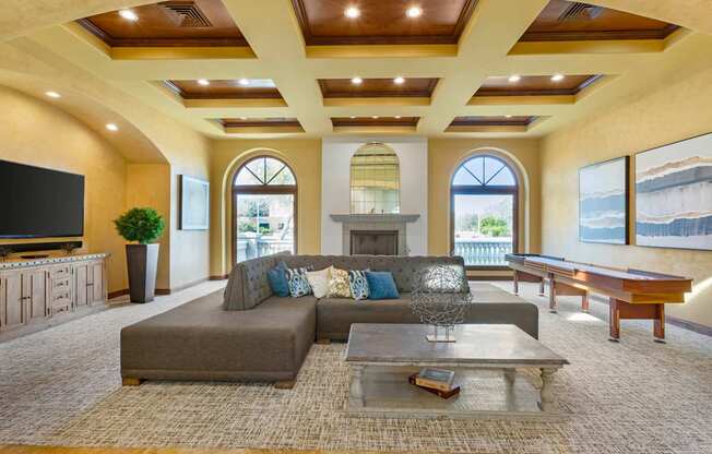 A living room with a grey couch and a coffee table.