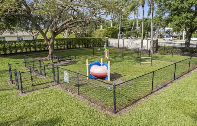 a playground with a ball in the middle of a fence