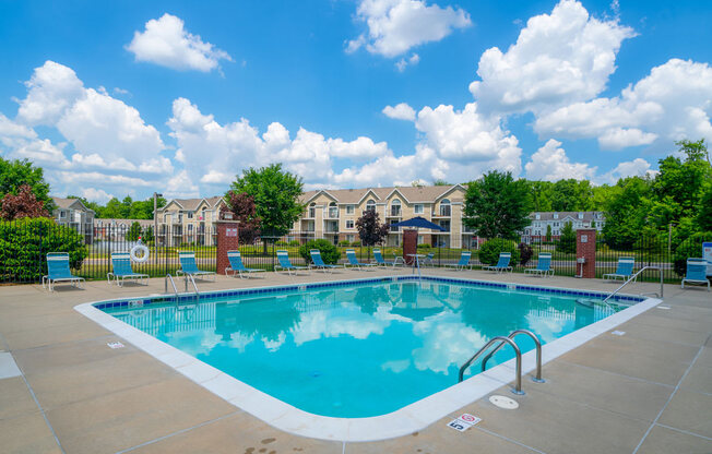 Relaxing Pool Area With Lounge Chairs at Trillium Pointe Apartment Homes, Jackson, Michigan