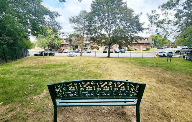 a park bench sitting in the grass