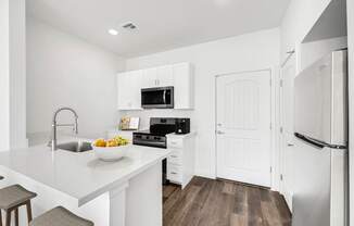 a kitchen with white cabinets and a white counter top