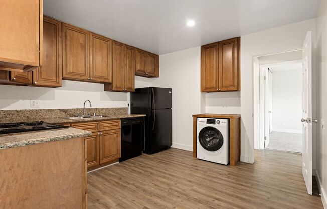 a kitchen with wooden cabinets and a washing machine