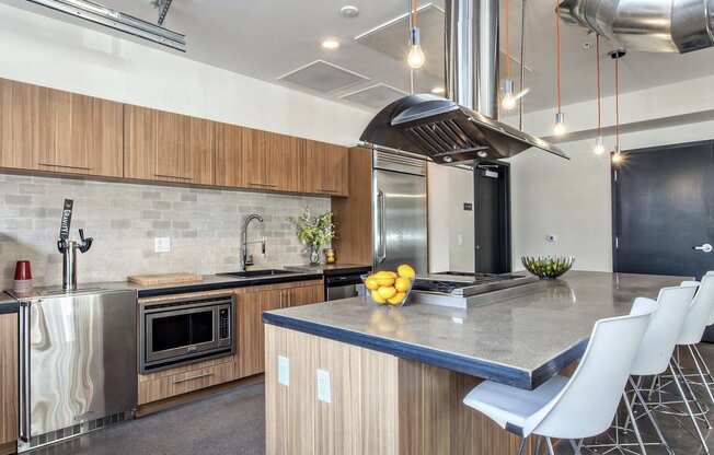 a kitchen with a large island and stainless steel appliances