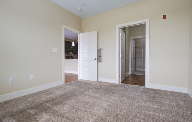 a bedroom with a carpeted floor and an open door