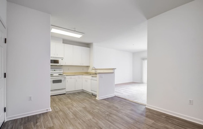 an empty kitchen and living room in a house