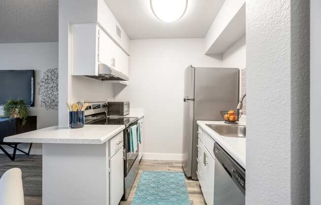 Phoenix AZ Apartments - Spacious Modern Kitchen With White Cabinets, White Countertops, and Stainless Steel Appliances
