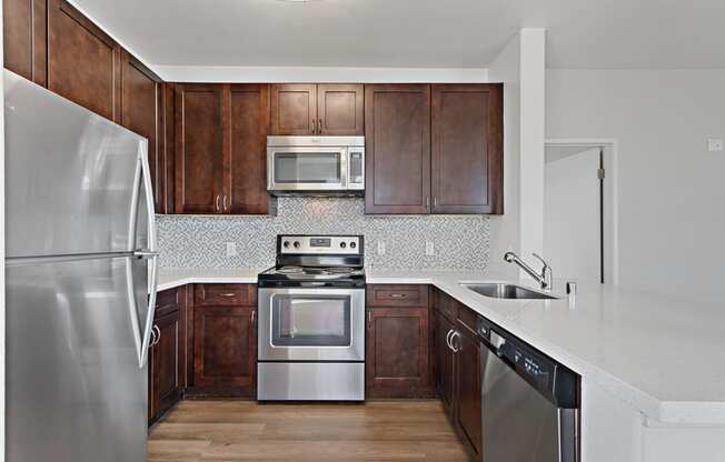 Kitchen with stainless steel appliances at Allegro at Jack London Square in Oakland, CA