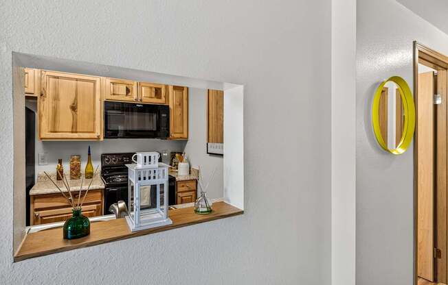 A kitchen with wooden cabinets and a white stove.